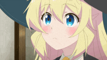 a girl with blonde hair and blue eyes wearing a witch hat