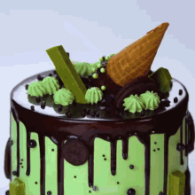 a cake with green frosting and a cone on top