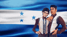 two men are standing in front of a blue and white flag