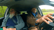 a man with a beard is sitting in the back seat of a car