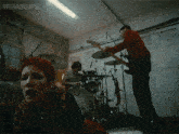 a group of people playing instruments in a garage with the words terasgifs written above them