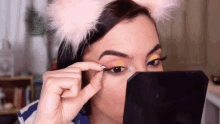 fixing fake eyelashes bilintina bilintina makeup eye makeup looking into mirror