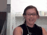 a woman wearing glasses and a lanyard that says ' nc state ' on it