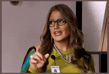 a woman wearing glasses and a name tag with imperio on it