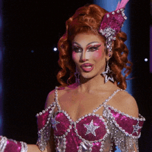 a woman in a pink and silver costume with a star on the chest