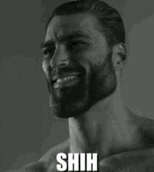 a man with a beard is smiling in a black and white photo with the words `` shh '' .