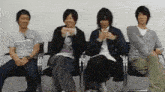 a group of people are sitting in chairs and talking