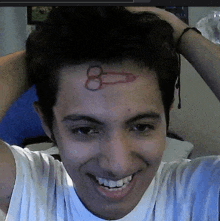 a young man with a penis tattoo on his forehead