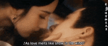 a man and a woman are kissing and the woman says as love melts like snow in the wind .