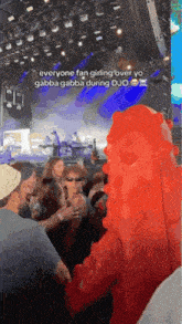 a group of people standing in front of a stage with a spongebob costume on