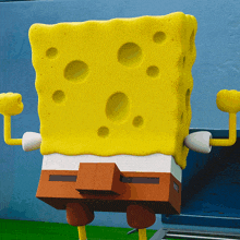 a yellow spongebob squarepants cartoon character flexes his muscles
