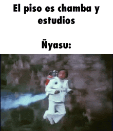 a man in a white suit is jumping in the air while holding a fire extinguisher in his hand