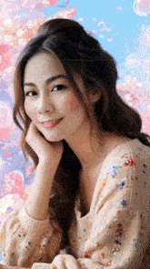 a woman in a floral sweater looks at the camera