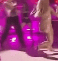 a blurry picture of a group of people dancing on a stage .