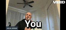 a man smoking a cigarette in a room with the words " you " on the bottom