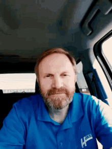 a man with a beard wearing a blue shirt that says css