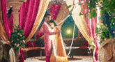 a man and a woman are hugging each other in a room with a lot of lights .