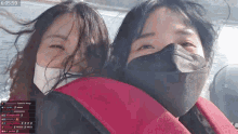 two women wearing face masks are sitting next to each other on a boat and the time is 6:05 59