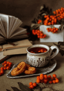 a cup of tea sits on a saucer next to some cookies and berries