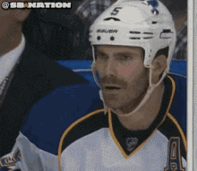 a hockey player wearing a helmet that says bauer
