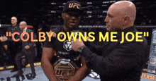 a man in a ufc hat is being pinned by another man