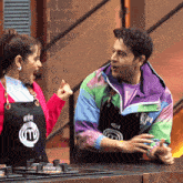a man and a woman wearing aprons that say masterchef