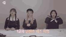 three girls wearing school uniforms are sitting at a table with the letters twice in pink letters