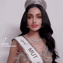 a woman is wearing a sash that says mut on it