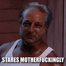 a man in a white tank top with the words stares motherfuckingly