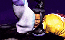 a man in a yellow shirt is being kicked in the face by another man