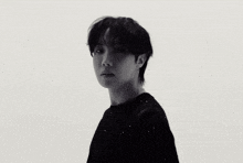 a black and white photo of a young man 's face looking up .