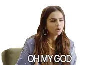 a woman is sitting on a couch with the words oh my god on her face
