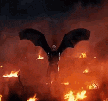 a person is flying through a field of fire with a dragon .
