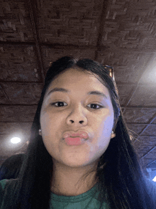 a girl with long black hair is making a face
