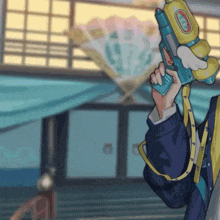 a cartoon character holding a water gun with the letter t on the front