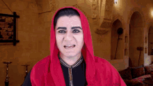 a man is wearing a red scarf around his head .