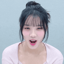 a girl with a bun in her hair looks at the camera