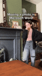 a woman standing in front of a fireplace with the words moving a photo in microsoft word above her