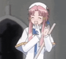 a girl with pink hair and a white hat is holding a broom and smiling .