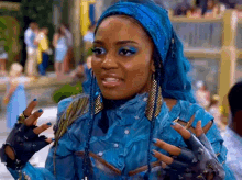 a woman with blue hair is wearing a blue outfit and gloves