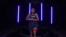 a woman wearing a uconn jersey with the number 2 on it