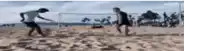 a blurry picture of two men playing soccer on the beach .