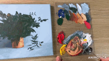 a painting of a plant next to a palette of paint with the words made in animotica on the bottom