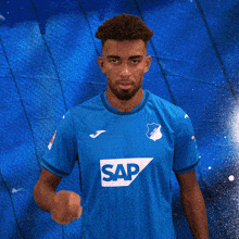 a man wearing a blue shirt with the word sap on the front