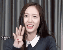 a woman with a ring on her finger is giving the ok sign