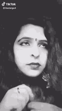 a black and white photo of a woman 's face .