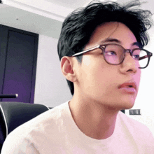 a close up of a person wearing glasses