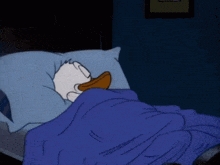 a cartoon duck is sleeping in a bed with a blue blanket