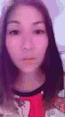 a close up of a woman 's face with a blurred background .