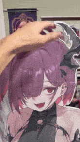 a person is touching a picture of a girl with purple hair .
